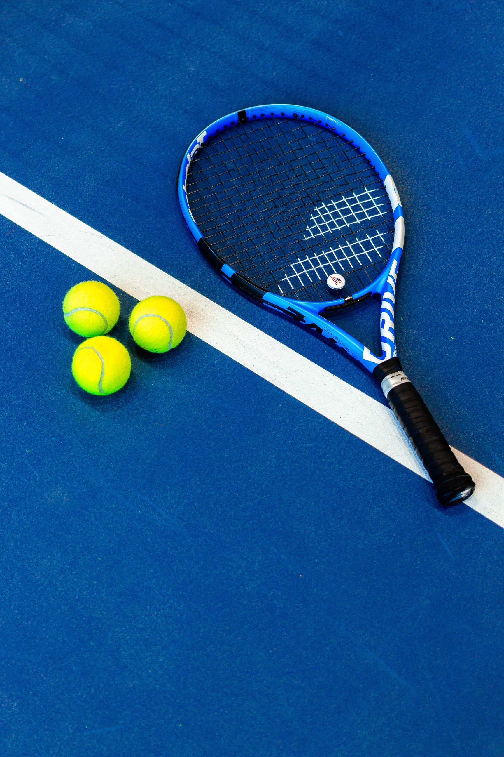 Blue Tennis Racket on the Ground